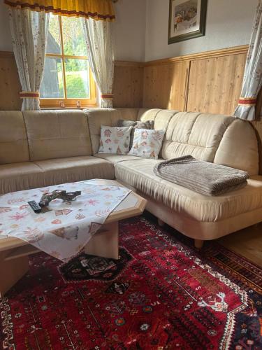 a living room with a couch and a coffee table at Wellnessalmhaus in Kloster