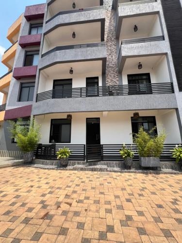 a building with potted plants in front of it at CosyNook in Kigali
