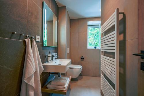 a bathroom with a sink and a toilet at PENZIÓN u JAKUBA & REŠTAURÁCIA Bezplatné Parkovanie in Martin