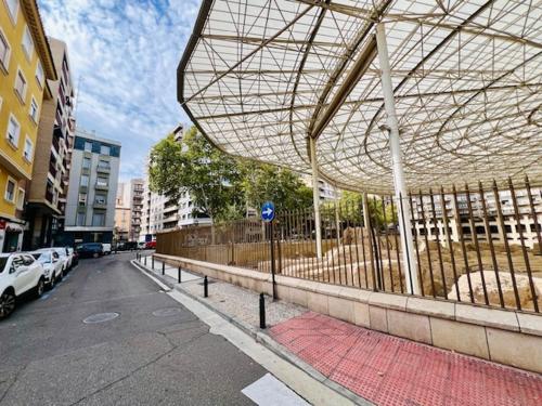 a building with a roof on the side of a street at Apartamento Nolasco in Zaragoza