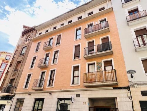 a large building with balconies on the side of it at Apartamento Nolasco in Zaragoza