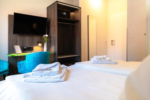 Postel nebo postele na pokoji v ubytování B M Hotel im Ludwig- Harms- Haus