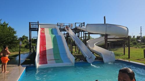 a person riding a water slide at a water park at Casa En Victoria Entre Ríos Salida Al Rio Pesca Cabaña in Victoria