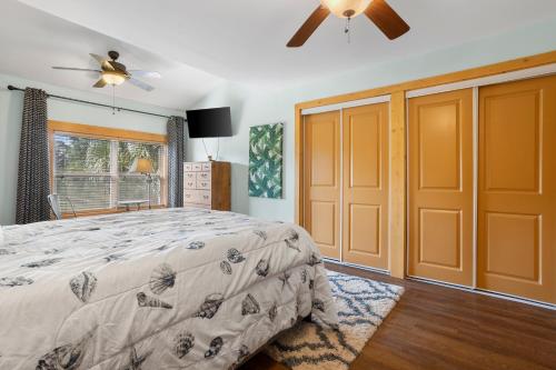 a bedroom with a bed and a ceiling fan at Pool Retreat Waterfront 6 Bedroom Boat Ramp Game Room Pass Christian Home in Pass Christian