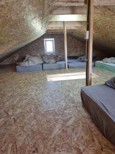 a room with two bunk beds in a attic at Namelis su sauna ir jakuzi in Virbališkiai