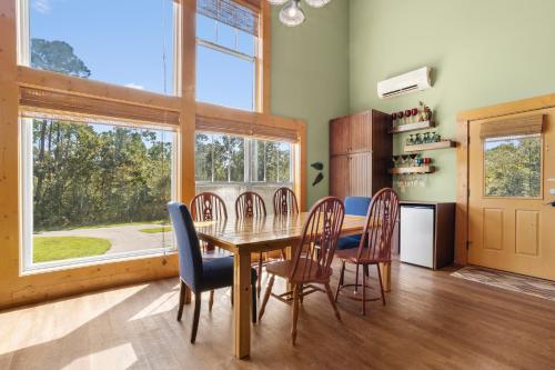 a dining room with a table and chairs and a window at Pool Retreat Waterfront 6 Bedroom Boat Ramp Game Room Pass Christian Home in Pass Christian