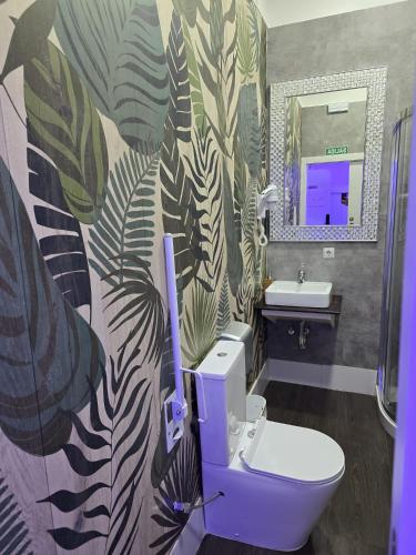 a bathroom with a purple toilet and a sink at Modular Rooms in Madrid