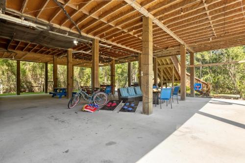 a large pavilion with bikes parked under it at Pool Retreat Waterfront 6 Bedroom Boat Ramp Game Room Pass Christian Home in Pass Christian