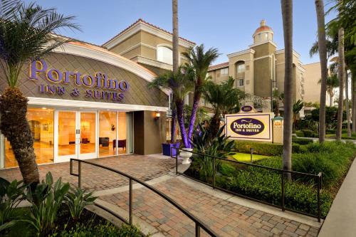 a building with a sign that reads rotating time and suites at Anaheim Portofino Inn & Suites in Anaheim