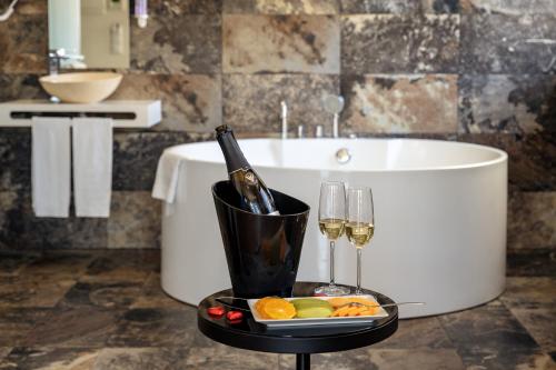 a tray with a bottle of champagne and a glass of wine at America Diamonds Hotel in Lisbon