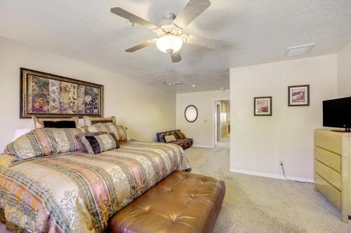 a bedroom with a bed and a ceiling fan at 2 Mi to Lake Apt with Balcony in Payson! in Payson