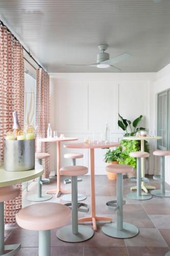 a room with a table and some stools at The Ryder Hotel in Charleston