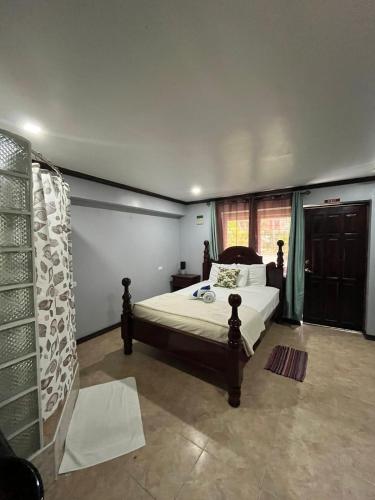 a bedroom with a bed and a window at Seaside Chateau Resort in Belize City