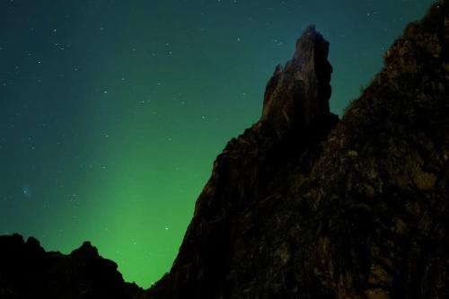 an image of a mountain under a green sky at Spectacular mountain views with fireplace and jacuzzi in Svolvær