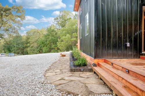 a house with a cat sitting outside of it at Sleeps 5-6 Near RRG-Hot Tub-Nice Sunrise-Quiet in Beattyville