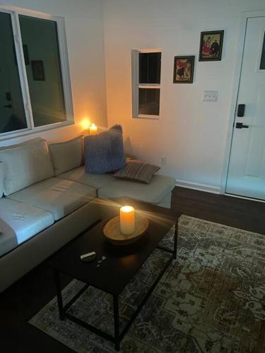 a living room with a couch and a candle on a table at Sleeps 5-6 Near RRG-Hot Tub-Nice Sunrise-Quiet in Beattyville