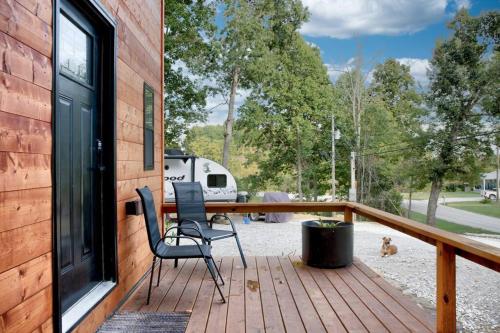 a deck with a chair and a table and a rv at Sleeps 5-6 Near RRG-Hot Tub-Nice Sunrise-Quiet in Beattyville