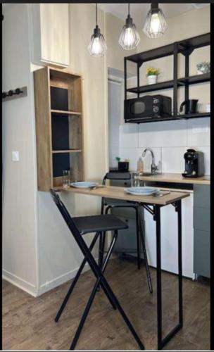 une cuisine avec une table et des chaises dans une pièce dans l'établissement la cale à la mer, à Dieppe