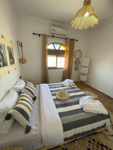 a bedroom with a large bed with two pillows at Dar Mgouna Roses in Kalaat MGouna
