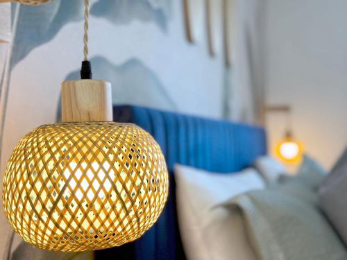 aendant light hanging in a room with a couch at Sunset Oasis with Movie Theatre, Heated Pool & Game Room in Pompano Beach