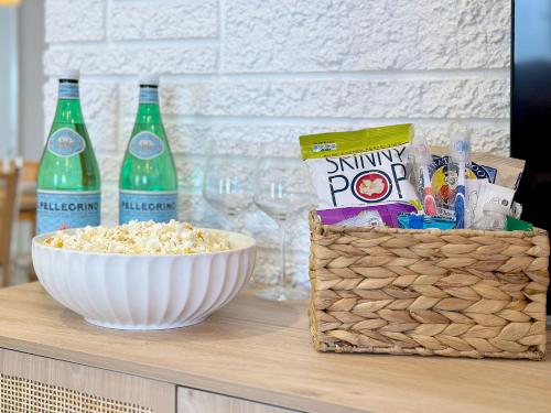 a table with a bowl of popcorn and two bottles of soda at Sunset Oasis with Movie Theatre, Heated Pool & Game Room in Pompano Beach