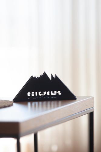 a black sign sitting on top of a table at Sunset in Zlatibor