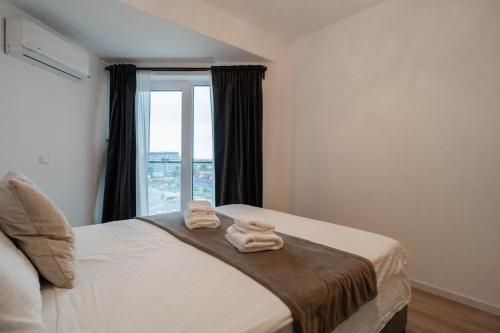 Ένα ή περισσότερα κρεβάτια σε δωμάτιο στο Vulcan Residences - Premium Apartments