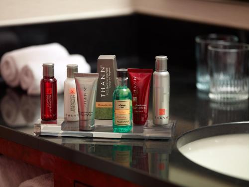 a counter with several bottles ofodorizers and a sink at Atlanta Marriott Northwest at Galleria in Atlanta
