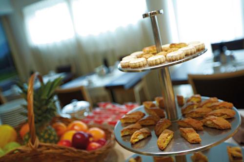 a table with three tiers of food on top at Albergo Celide in Lucca