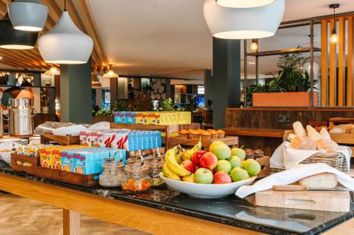 a buffet with fruits and vegetables on a table at voco Winchester Hotel & Spa by IHG in Winchester