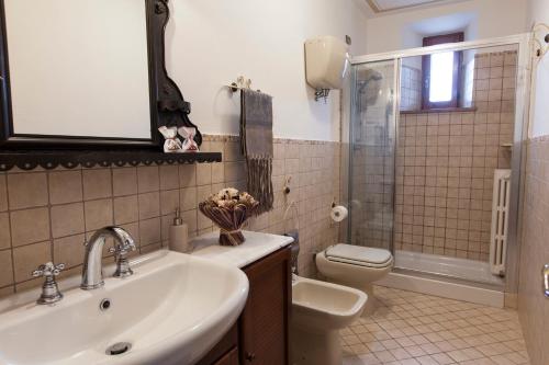 a bathroom with a sink and a toilet at Casolare Santa Margherita in Assisi