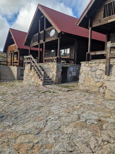 a large building with a stone path in front of it at Chalé 40 - Penhas da Saúde in Penhas da Saúde