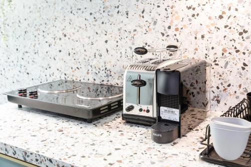 a coffee maker sitting on top of a counter at Stylish & Modern City Escape In Bonnevoie in Luxembourg
