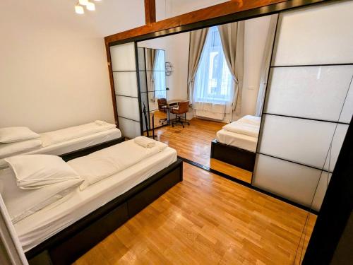 a room with two beds and a mirror at Ó 38 Family Luxe in Budapest