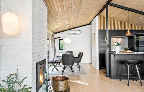 a dining room with a fireplace and a dining table at 3 Bedroom Stunning Home In Strøby in Strøby