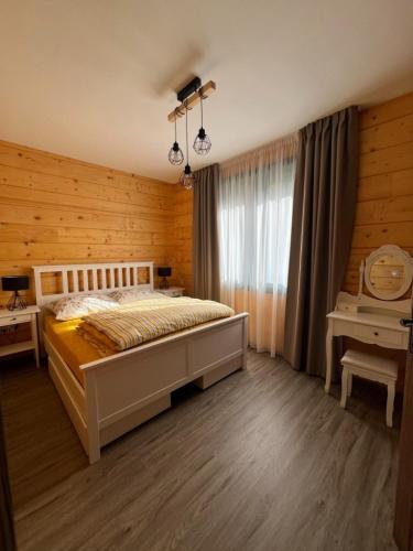 a bedroom with a large bed and a window at Roubenka Na Číně in Želiv
