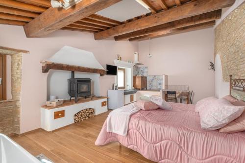 a large bedroom with a bed and a fireplace at Casa Serena in Vicopisano