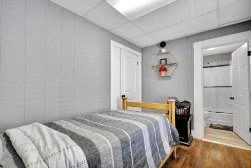 a bedroom with a bed and a clock on the wall at Charming 1 Bedroom, Apartment House in Lansing in Lansing