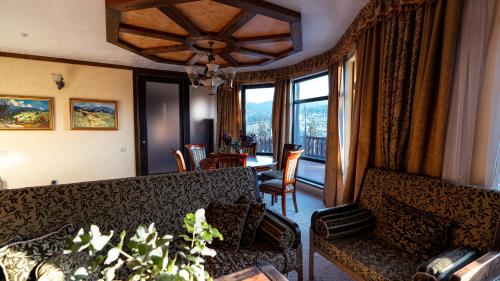 a living room with a couch and a table with chairs at Nordian chalet next to Bukovel ski lift in Bukovel