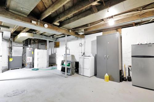an empty garage with refrigerators and appliances in it at Charming 1 Bedroom, Apartment House in Lansing in Lansing
