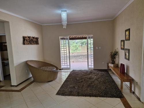 a living room with a door open to a patio at Chacara espetacular em condomínio fechado in Ribeirão Preto