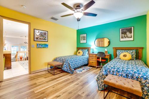 two beds in a room with green and yellow walls at Sunny Titusville Retreat Near Space Coast! in Titusville