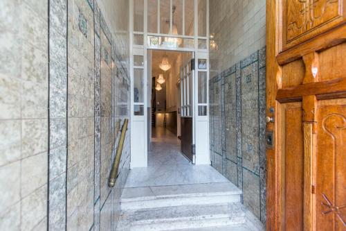 a hallway with tiles on the walls of a house at Grand Canal Boutique Hotel in Amsterdam