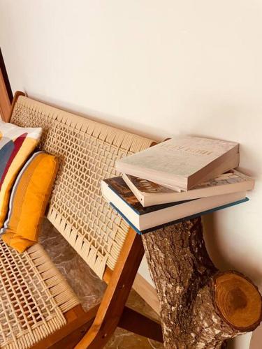 a pile of books sitting on top of a bench at Bienvenidos a la Pequeña Selva de Legnalife in Homestead