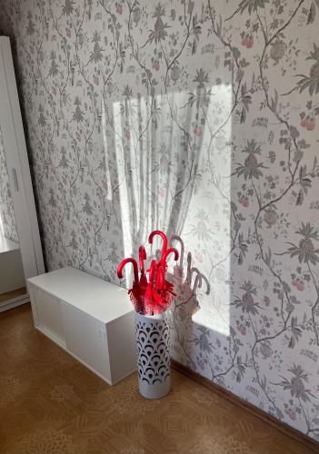 a vase filled with candy canes in front of a window at Kulautuva Park Apartments in Kulautuva