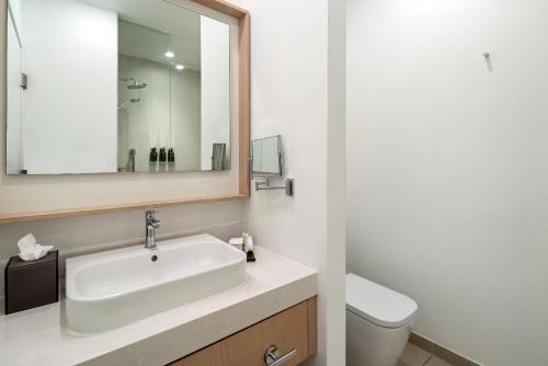 a bathroom with a sink and a toilet at The Grayson Hotel Miami Downtown in Miami