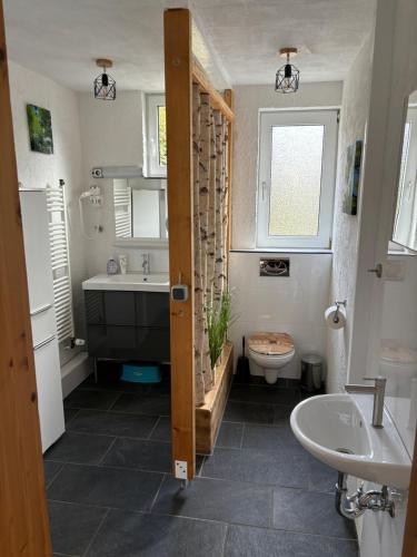 a bathroom with a tub and a sink and a toilet at Fischer Hütte in Sankt Andreasberg