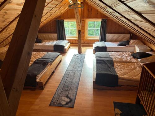a room with four beds in a attic at Fischer Hütte in Sankt Andreasberg