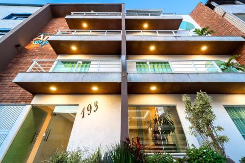 an apartment building with a number on the side of it at Pousada Areia do Forte in Cabo Frio