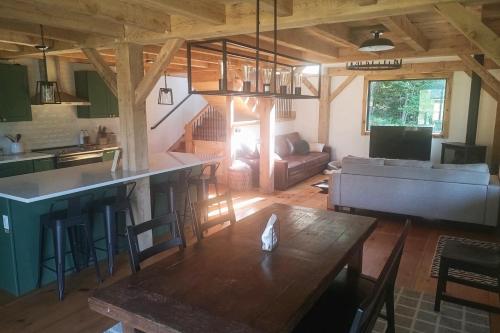a kitchen and living room with a table in a room at The Hollow in Plymouth